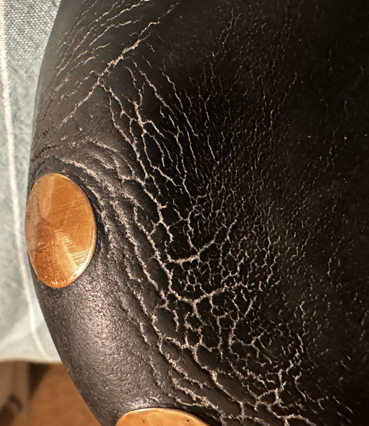 Close-up of saddle with cracked leather.