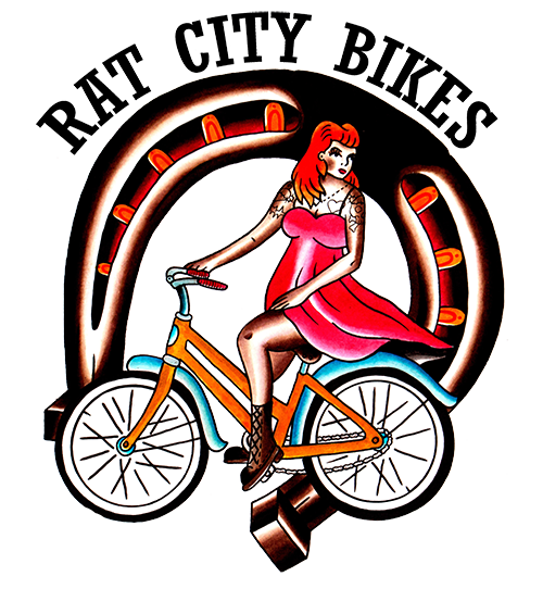 Rat City Bikes logo: Woman on a bike with horeshoe arch.>

<div class=